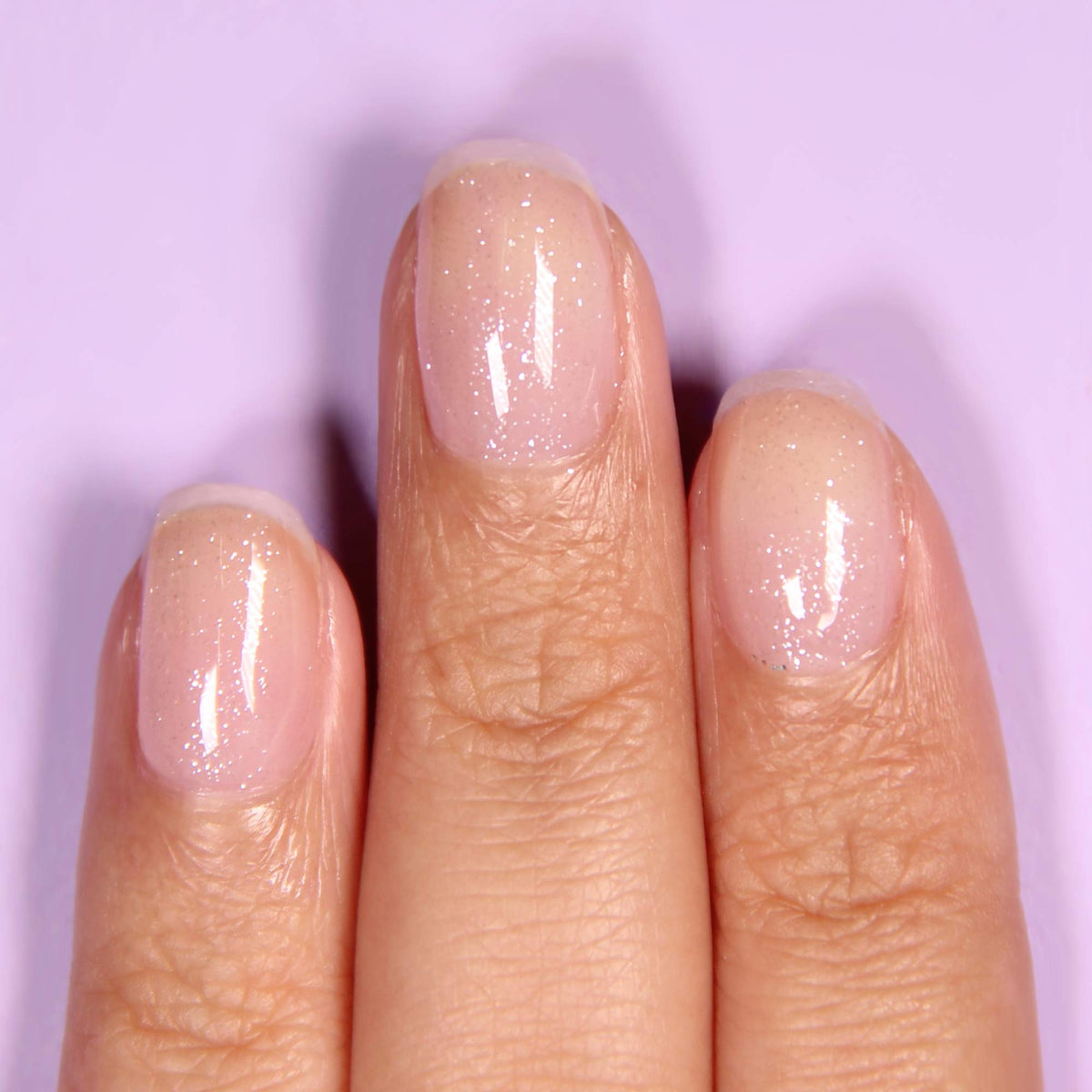 LONDONTOWN kur Top Coat close-up of iridescent texture enhancing sparkle benefit