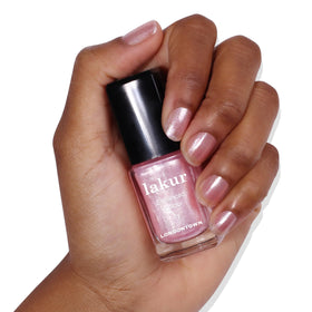 LONDONTOWN finished manicure on hands in lifestyle setting for long-lasting shine benefit