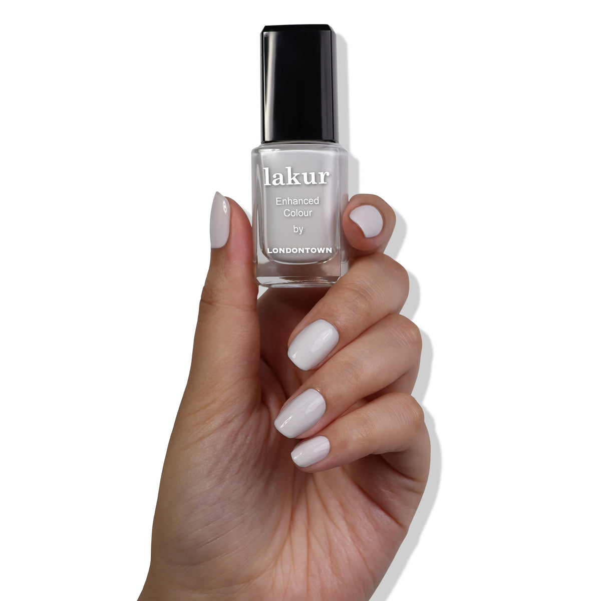 LONDONTOWN mani lifestyle scene modern desk setup showcasing neutral nails