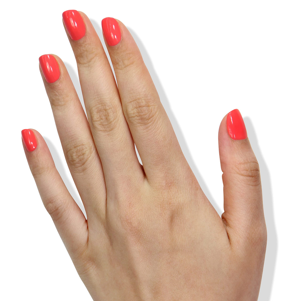 LONDONTOWN Lakur Papaya bottle beside manicured fingers for size and true-color reference
