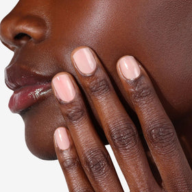 LONDONTOWN lifestyle shot of hands at cafe wearing apricot beige for everyday elegance