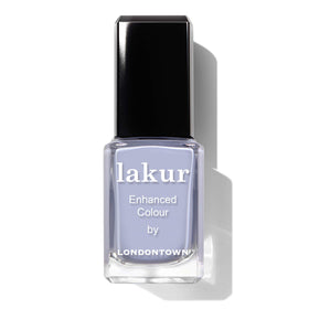 LONDONTOWN manicure on hands at table showcasing everyday wearability benefit