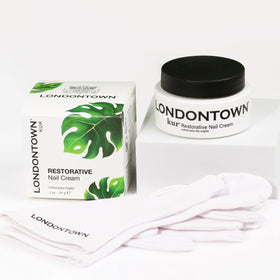 LONDONTOWN 1 fl oz tube beside a coin for clear size and scale guidance