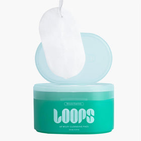 LOOPS milky oil texture on fingertip highlighting nourishing formula and hydrating feel