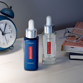 L'Oreal Paris serums styled on bathroom shelf to suggest everyday skincare integration
