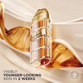 L'Oreal Paris bottle held in hand to show real scale and travel-friendly size