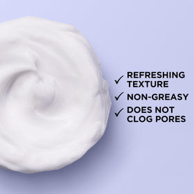 L'Oreal Paris applying cream with fingertips to demonstrate smooth, fast-absorbing application benefit
