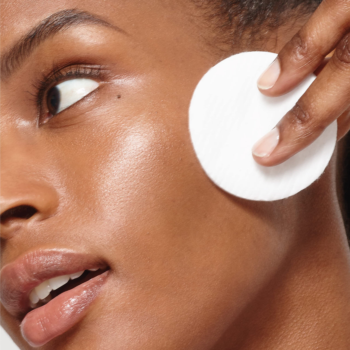 L'Oreal Paris applying toner with cotton pad for refreshed skin