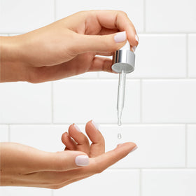 L'Oreal Paris serum on bathroom counter at night showing routine convenience benefit