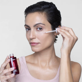 L'Oreal Paris 30ml bottle beside common items showing scale and travel-friendly benefit