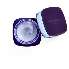 L'Oreal Paris jar next to coin to show 1.7 oz scale for sizing benefit