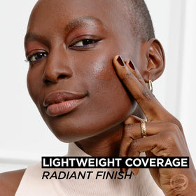 L'Oreal Paris 1 fl oz bottle beside common objects to show compact size and travel-friendly benefit