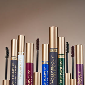 L'Oreal Paris tube next to coin showing compact size and travel benefit