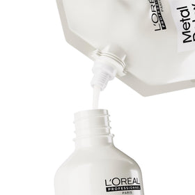 L'Oréal Professionnel refill beside 16.91 fl oz bottle for scale reference