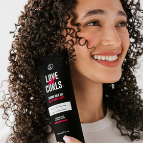 Love Ur Curls applying gel to soaking wet hair for even distribution benefit