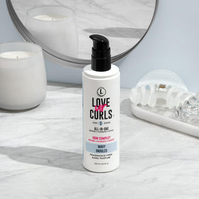 Person scrunching wavy hair with Love Ur Curls cream applied to define and reduce frizz