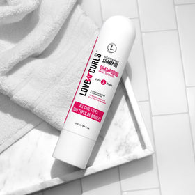 Love Ur Curls in shower with curly-haired person using product for defined manageable curls