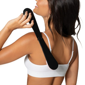 Loving Tan applying self-tan to back demonstrating streak-free coverage