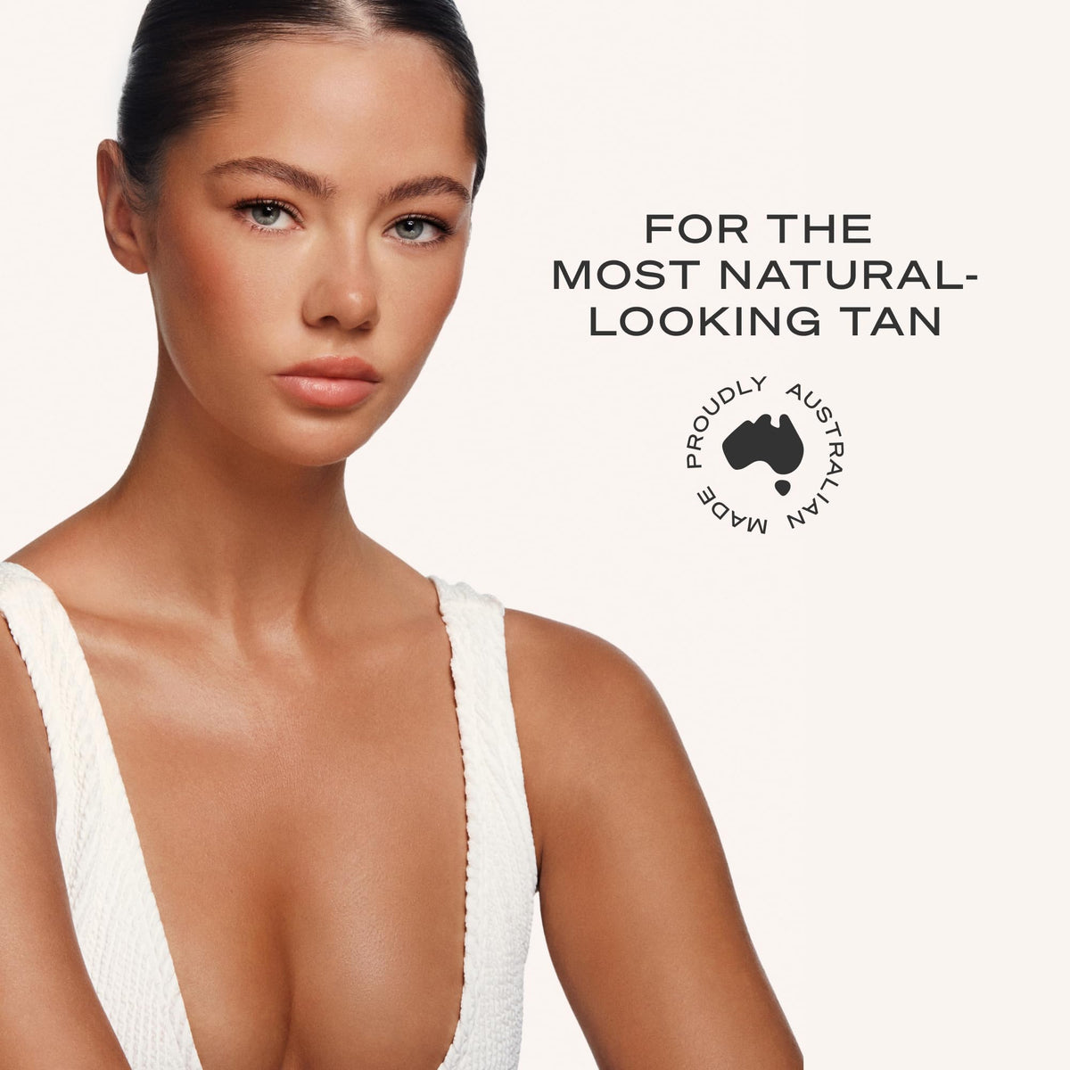 Loving Tan bottle held in hand to show 4 fl oz size and number of applications