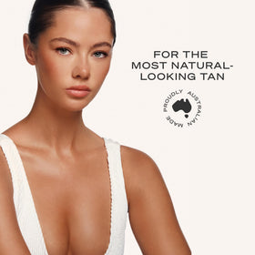 Loving Tan bottle held in hand to show 4 fl oz size and number of applications