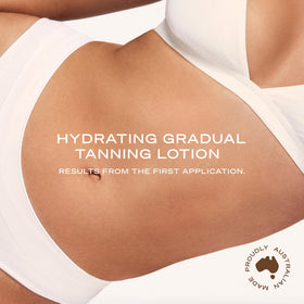 Loving Tan bottle held in hand to show compact size and ease of daily use