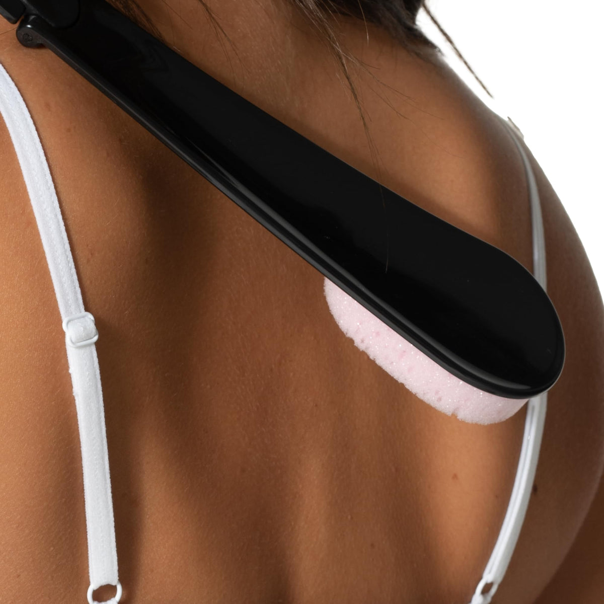 Loving Tan folded applicator beside hand showing portable storage benefit