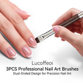 Lucoffeoi brush held next to fingers to show size and ergonomic wooden handle