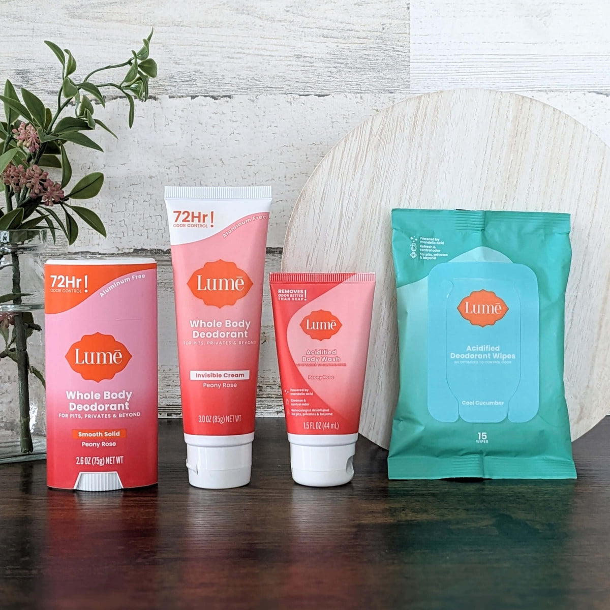 Lume Acidified Body Wash mini bottle in hand illustrating travel-size odor control
