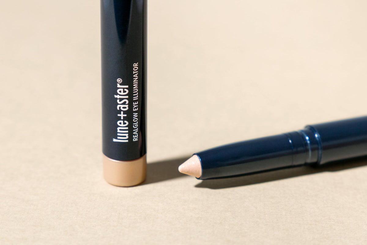 Lune+Aster crayon beside lipstick for scale and travel-friendly convenience