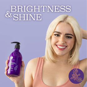 Luseta applying conditioner in shower on blonde hair for brass control