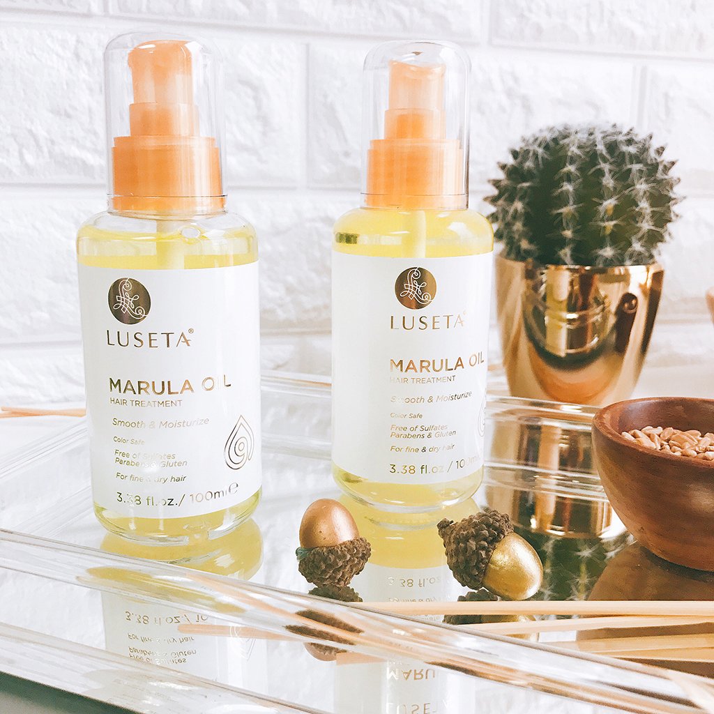 Luseta oil drop on hair strand illustrating absorption and added shine for fine hair