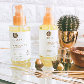 Luseta oil drop on hair strand illustrating absorption and added shine for fine hair