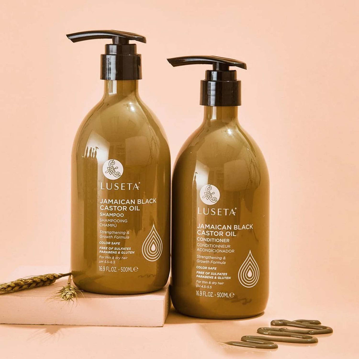 Luseta size scale next to hand showing 16.9 oz bottles