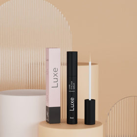 LUXE bottle in hand to show compact 3mL travel-friendly benefit
