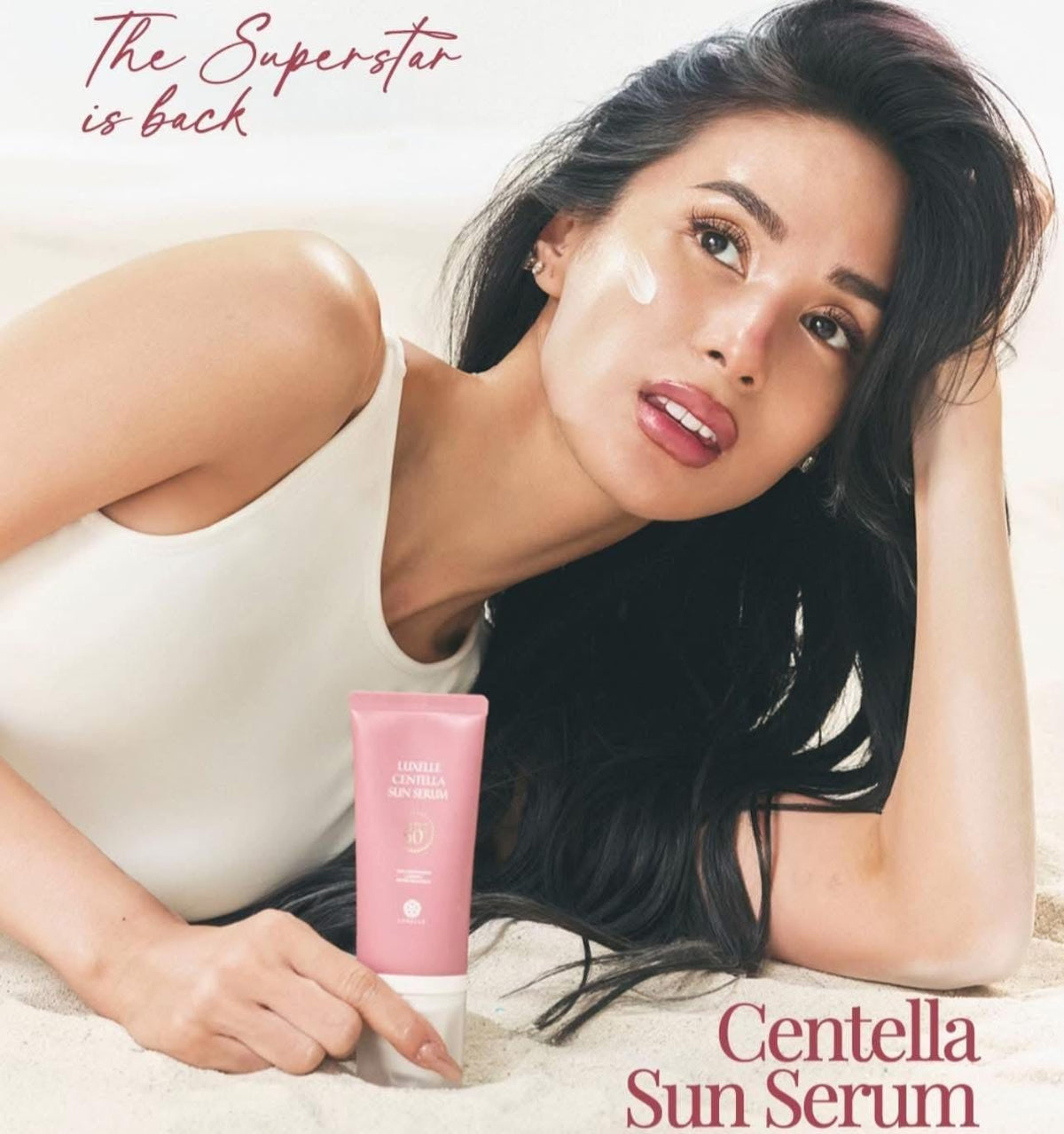 LUXELLE applying serum to cheek demonstrating lightweight non-greasy feel