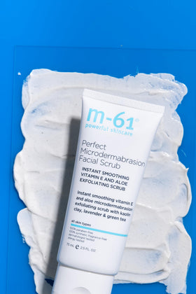 m-61 tube beside a coin to show 2.5 fl oz size, travel-friendly
