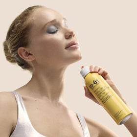 m-61 close-up of fine clear mist texture revealing even coverage benefit