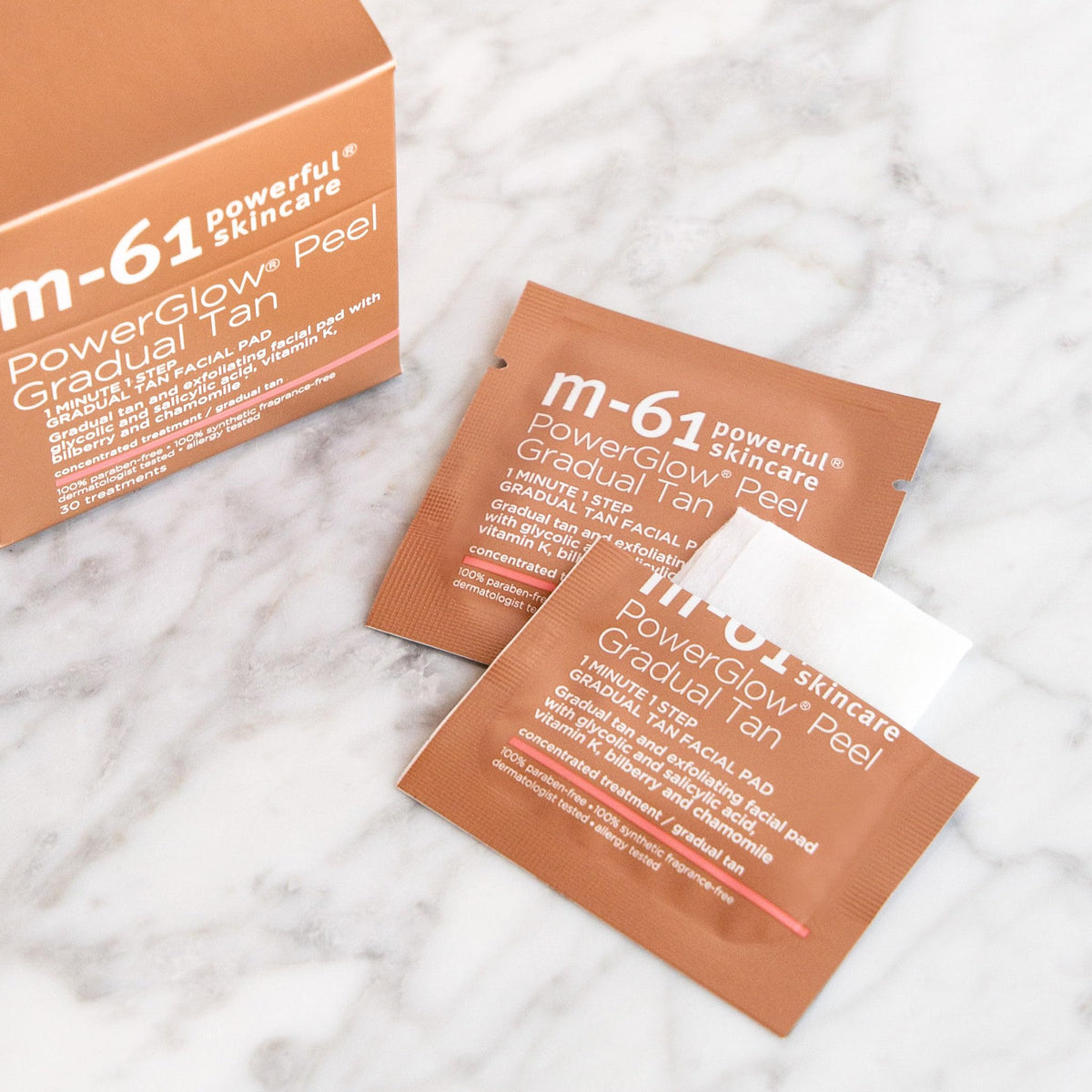 m-61 pad applied to cheek demonstrating even tan application benefit