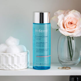 m-61 PowerGlow toner size comparison next to hand illustrating bottle scale and travel convenience