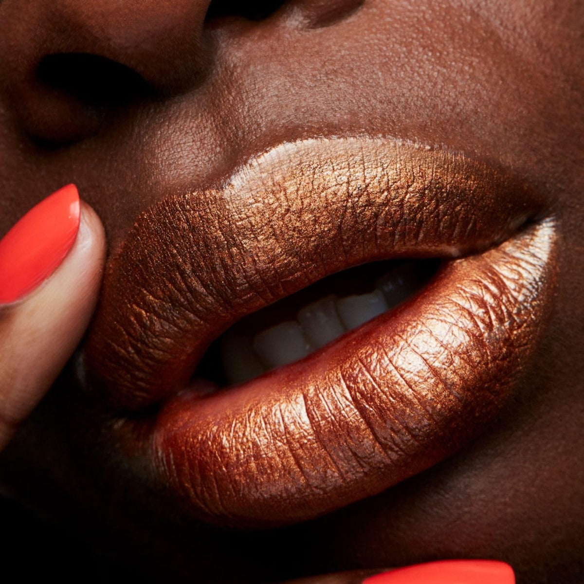 MAC Bronze Shimmer swatch on arm displaying true bronze shimmer and buildable coverage