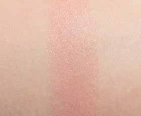 MAC lipstick swatch on arm revealing muted peach-beige color payoff and buildable coverage