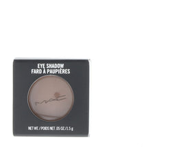 M·A·C matte charcoal brown eye shadow inside a makeup bag illustrating travel-ready convenience