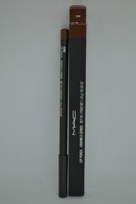 MAC lip pencil beside hand for scale showing compact travel-friendly size