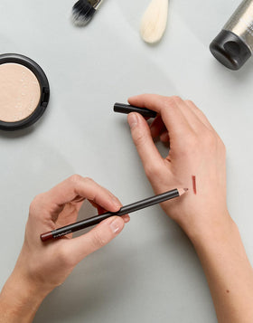 MAC lip pencil Mahogany beside lipstick demonstrating layering benefit
