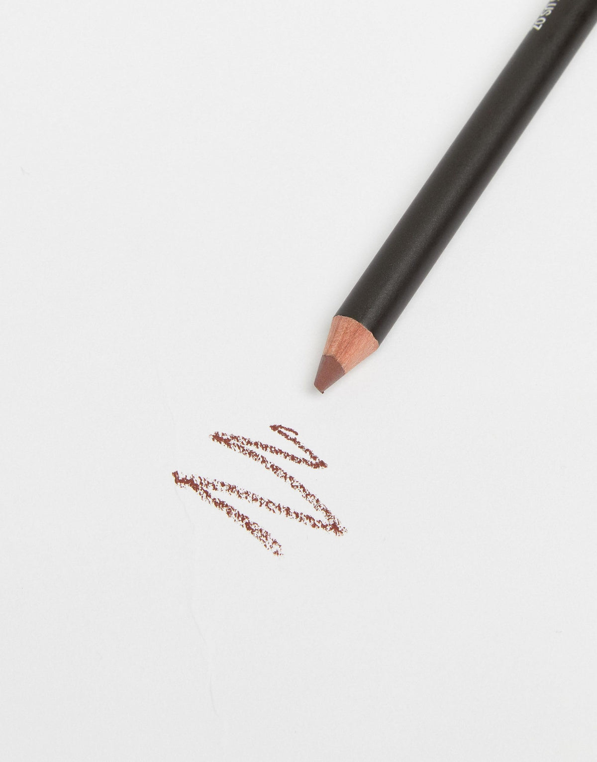 MAC lip pencil Mahogany next to coin for size comparison and portability