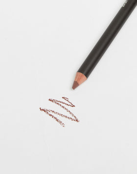 MAC lip pencil Mahogany next to coin for size comparison and portability