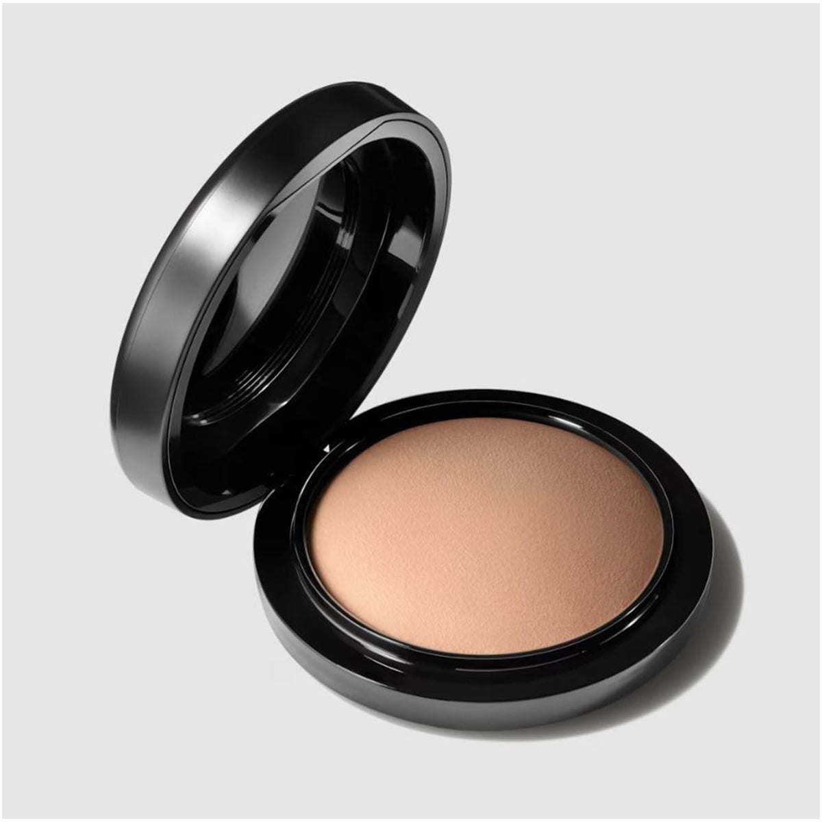 MAC powder swatched with brush showing finely milled texture and blendability