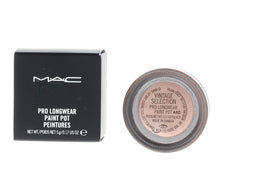 MAC paint pot next to palette showing coordination with powder shadows