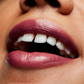 MAC Plum Dandy on lips lifestyle shot illustrating polished semi-lustrous look
