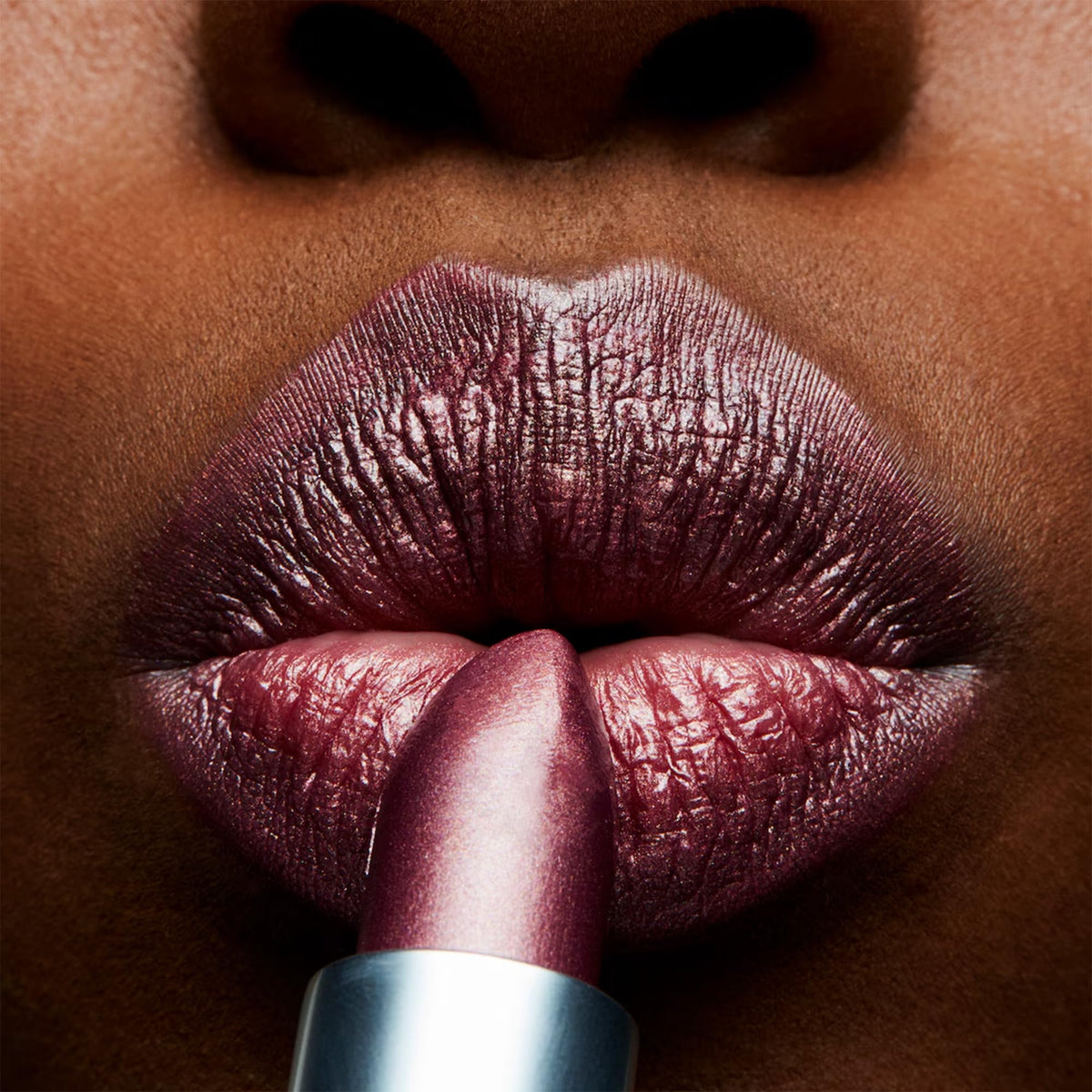 MAC Plum Dandy swatch on skin demonstrating buildable plum coverage